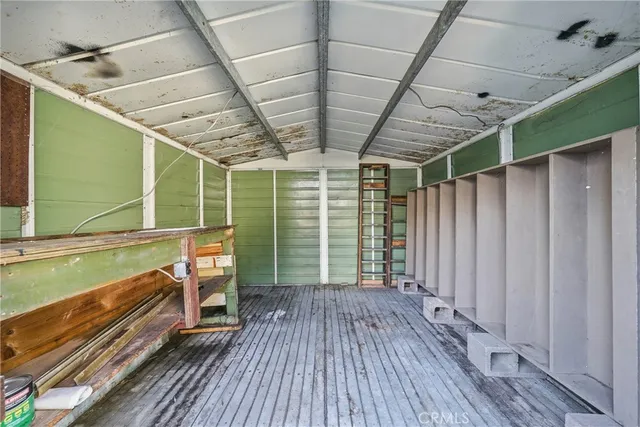 an aerial view of a house with a garden and trees