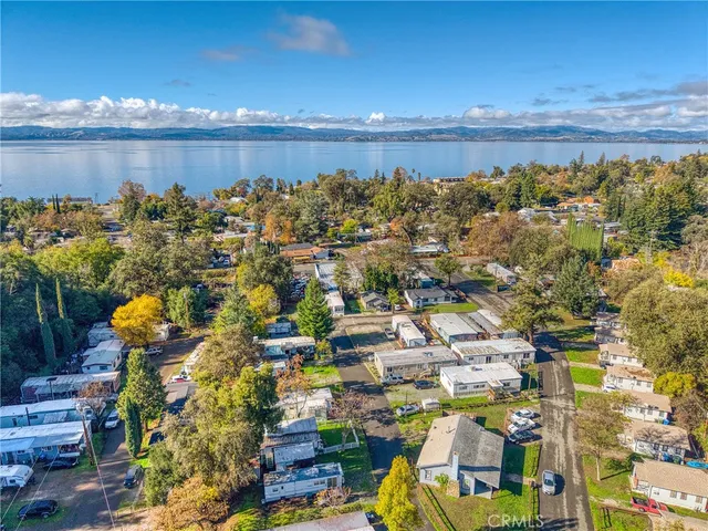 an aerial view of a house with a garden and lake view
