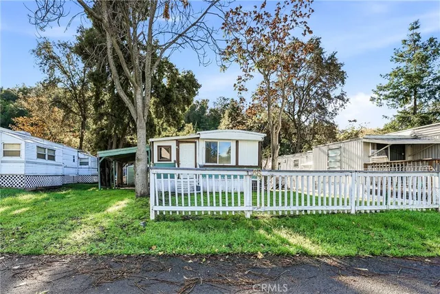 a view of a house with a yard and deck