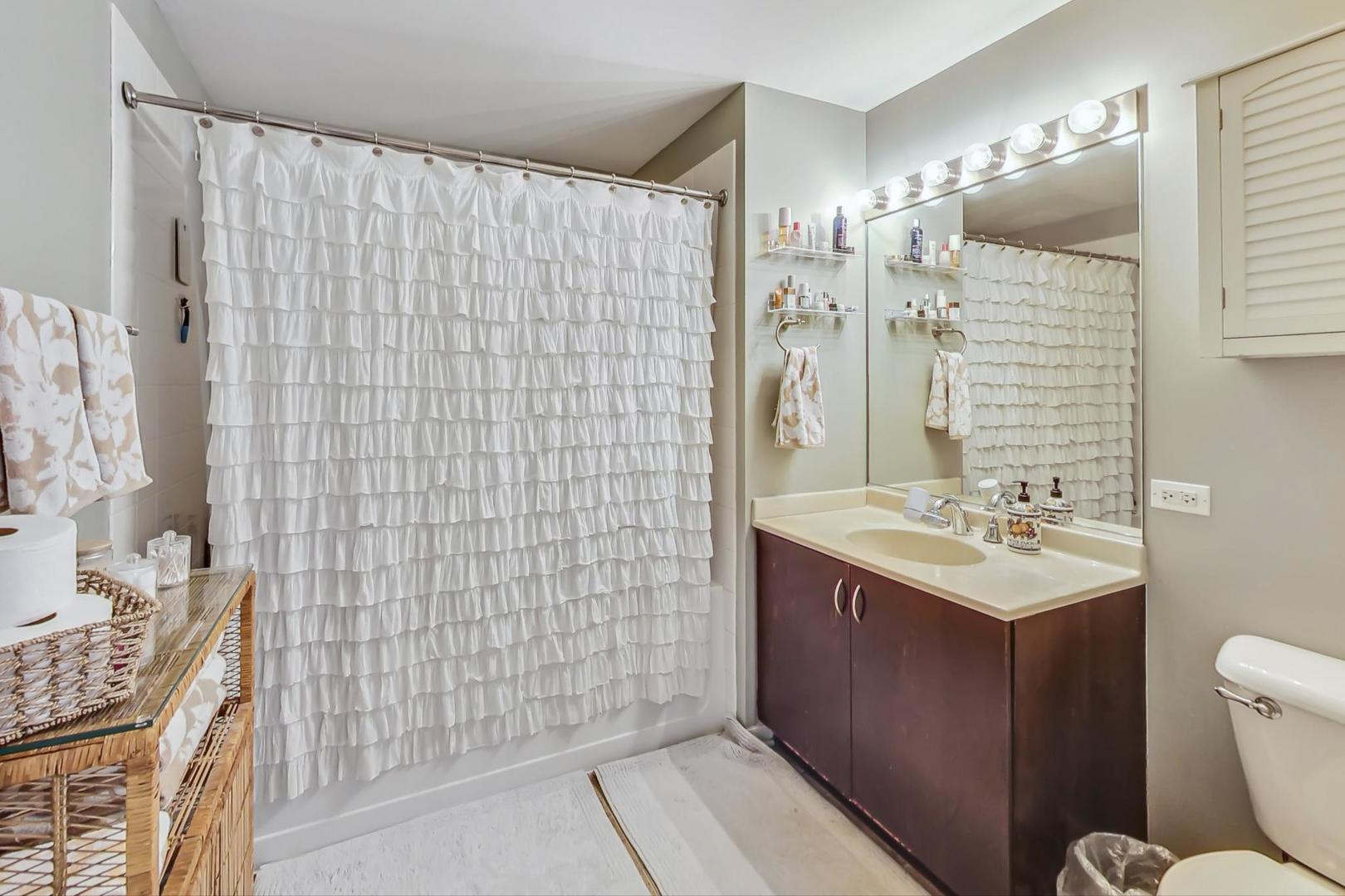 437 West Division Street, Unit 705 Chicago, IL 60610 - Photo 12 of 23 a bathroom with a sink toilet and shower