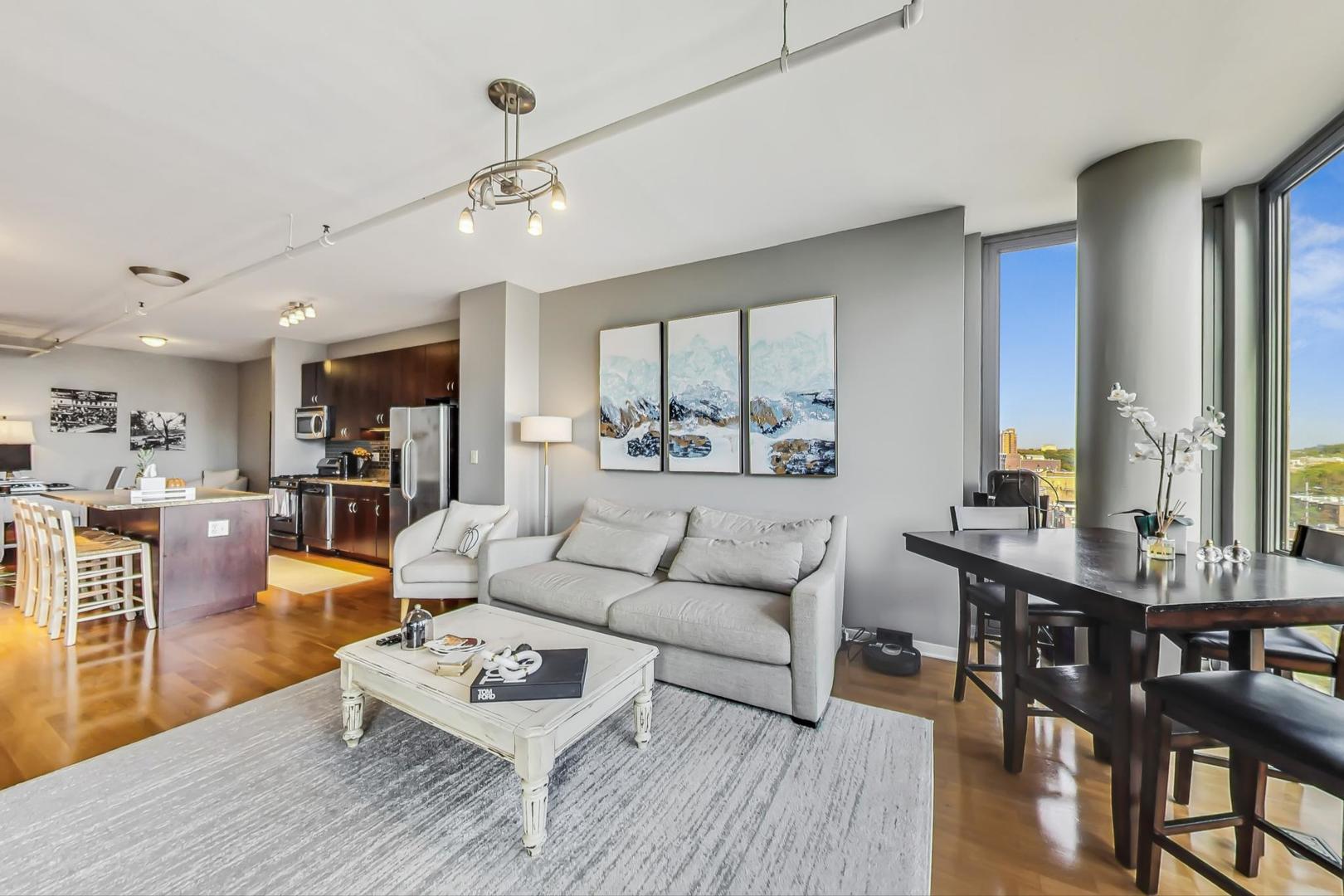 437 West Division Street, Unit 705 Chicago, IL 60610 - Photo 3 of 23 a living room with furniture kitchen view and a wooden floor