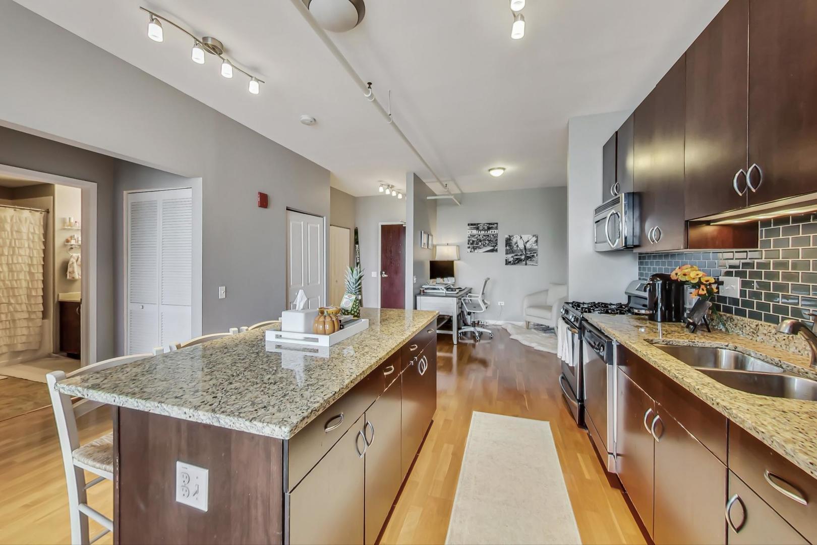 437 West Division Street, Unit 705 Chicago, IL 60610 - Photo 7 of 23 a kitchen with sink stove and cabinets