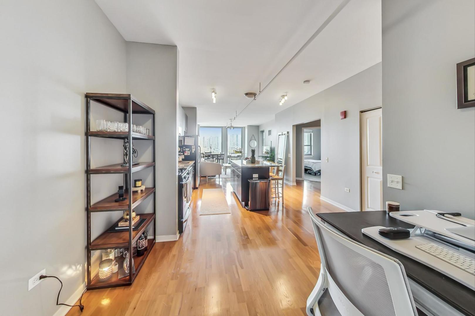 437 West Division Street, Unit 705 Chicago, IL 60610 - Photo 8 of 23 a living room with furniture and a wooden floor