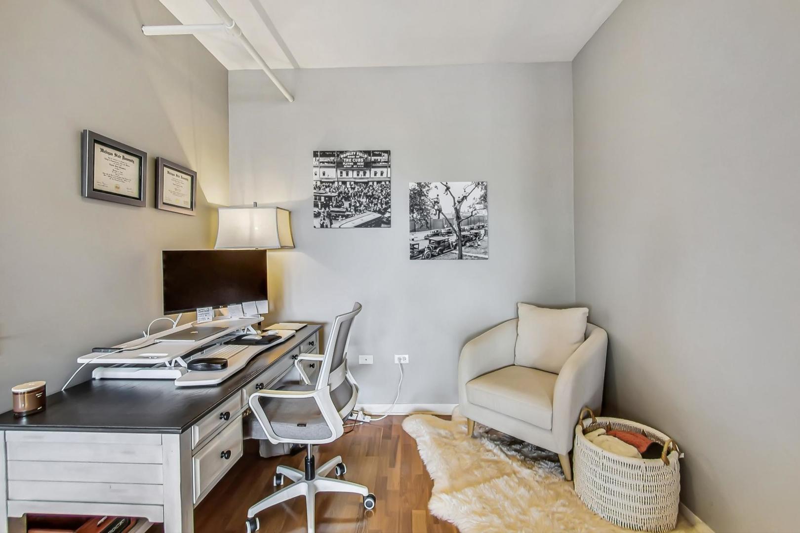 437 West Division Street, Unit 705 Chicago, IL 60610 - Photo 9 of 23 a bedroom with a bed and a chair