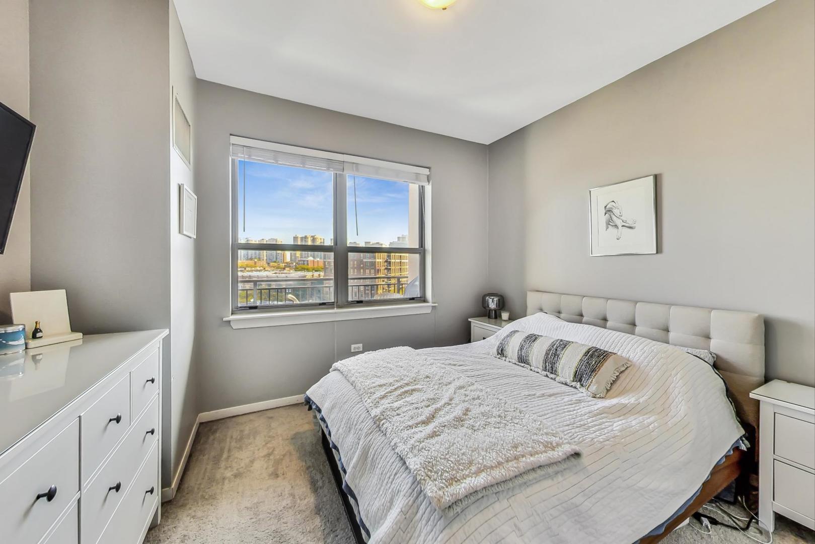437 West Division Street, Unit 705 Chicago, IL 60610 - Photo 10 of 23 a bedroom with a bed and a window