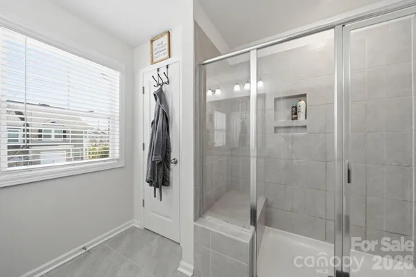 a bathroom with a glass shower door