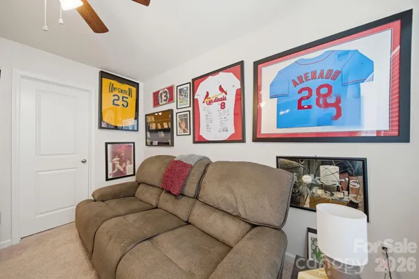 a living room with furniture and a bed