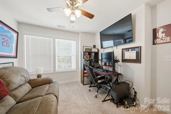 a view of a livingroom with workspace and a window