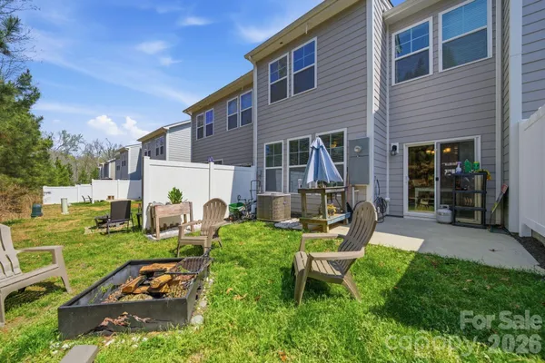 a view of a house with backyard porch and sitting area