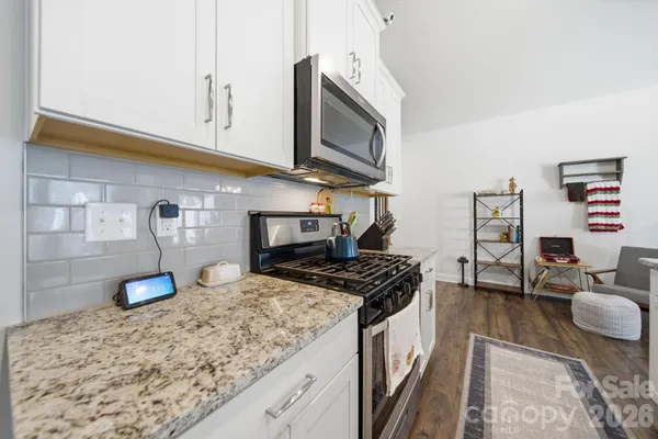 a kitchen with stainless steel appliances granite countertop a stove and a sink