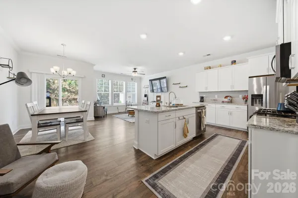 a kitchen that has a lot of cabinets a sink and a stove in it