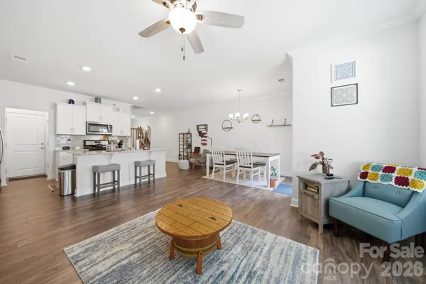 a living room with furniture and kitchen view