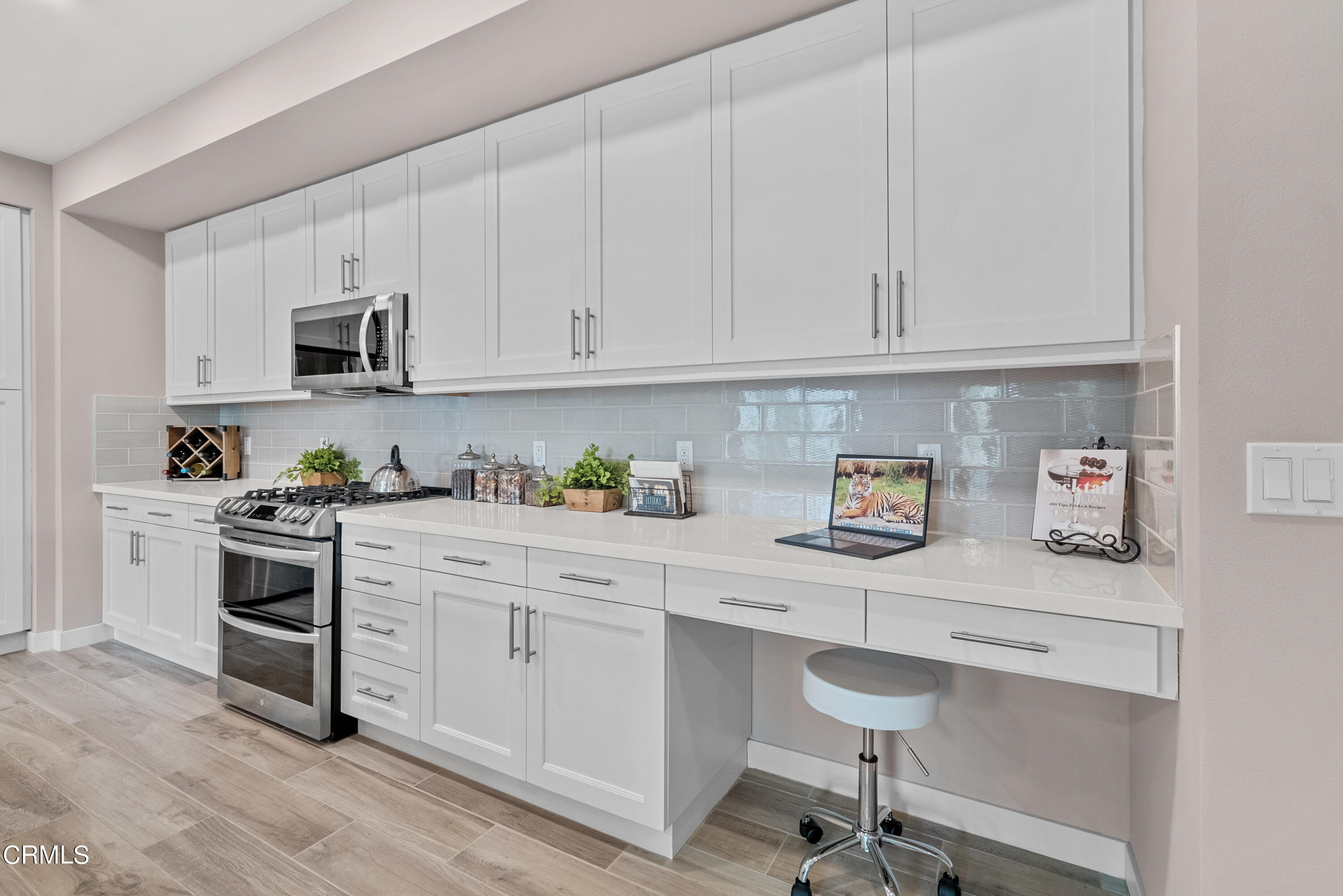 2860 Wagon Wheel Road, Unit 201 Oxnard, CA 93036 - Photo 14 of 30 a kitchen with white cabinets and appliances