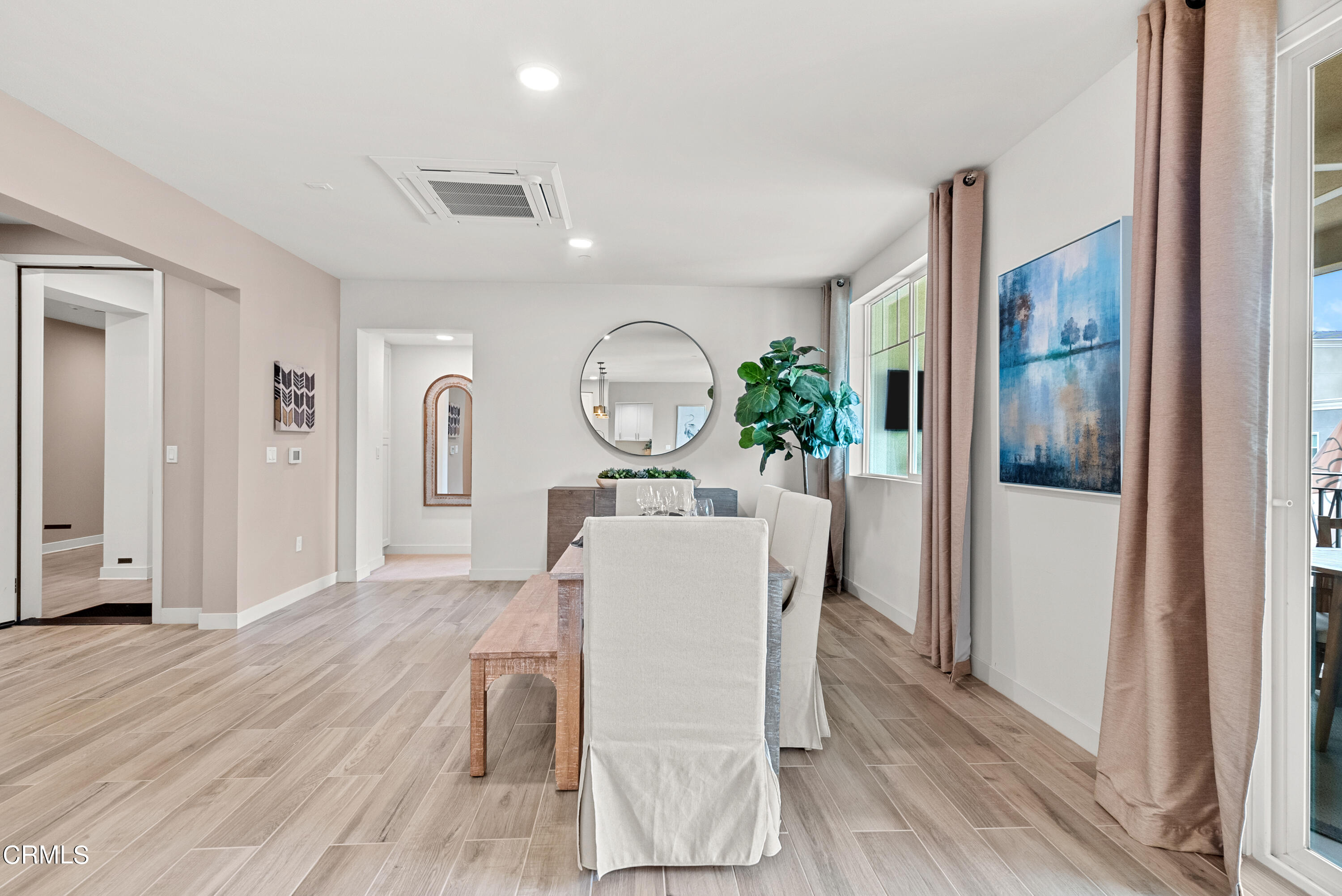 2860 Wagon Wheel Road, Unit 201 Oxnard, CA 93036 - Photo 4 of 30 a living room with furniture a large mirror and a wooden floor