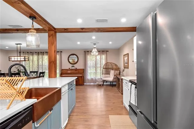 a kitchen with stainless steel appliances granite countertop sink stove and refrigerator
