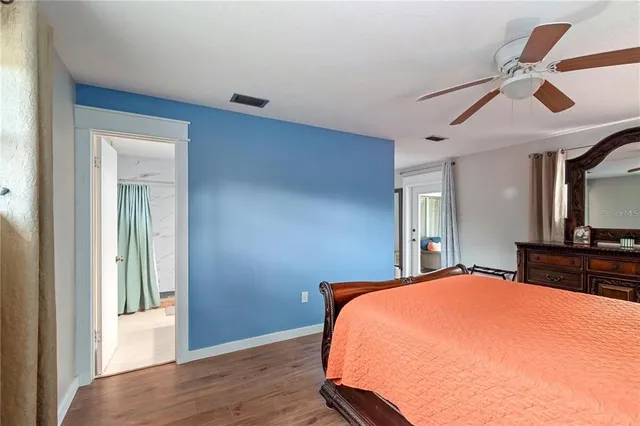 a bedroom with a large bed and a chandelier