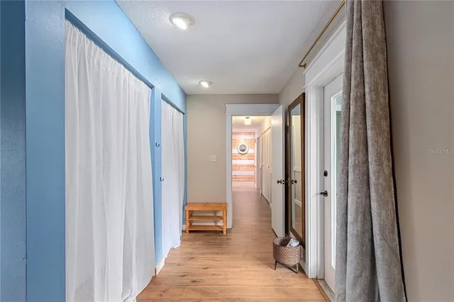 a view of a hallway with bathroom and shower