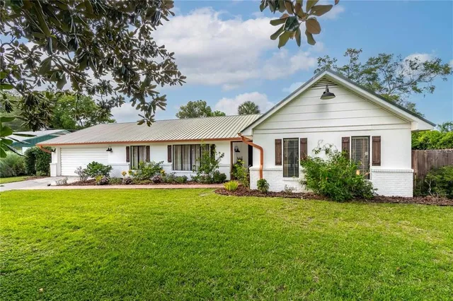 a front view of a house with a garden and porch