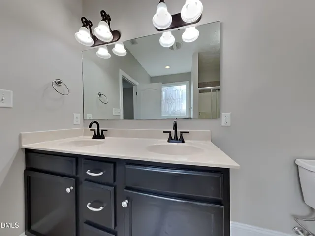 a bathroom with a sink a light fixture and a light fixture