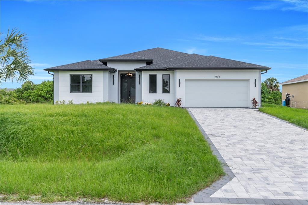2328 Irondale Road North Port, FL 34287 - Photo 2 of 45 a front view of a house with a yard and garage