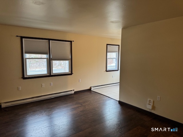 472 Cow Hill Road Groton, CT 06355 - Photo 3 of 11 an empty room with wooden floor and windows