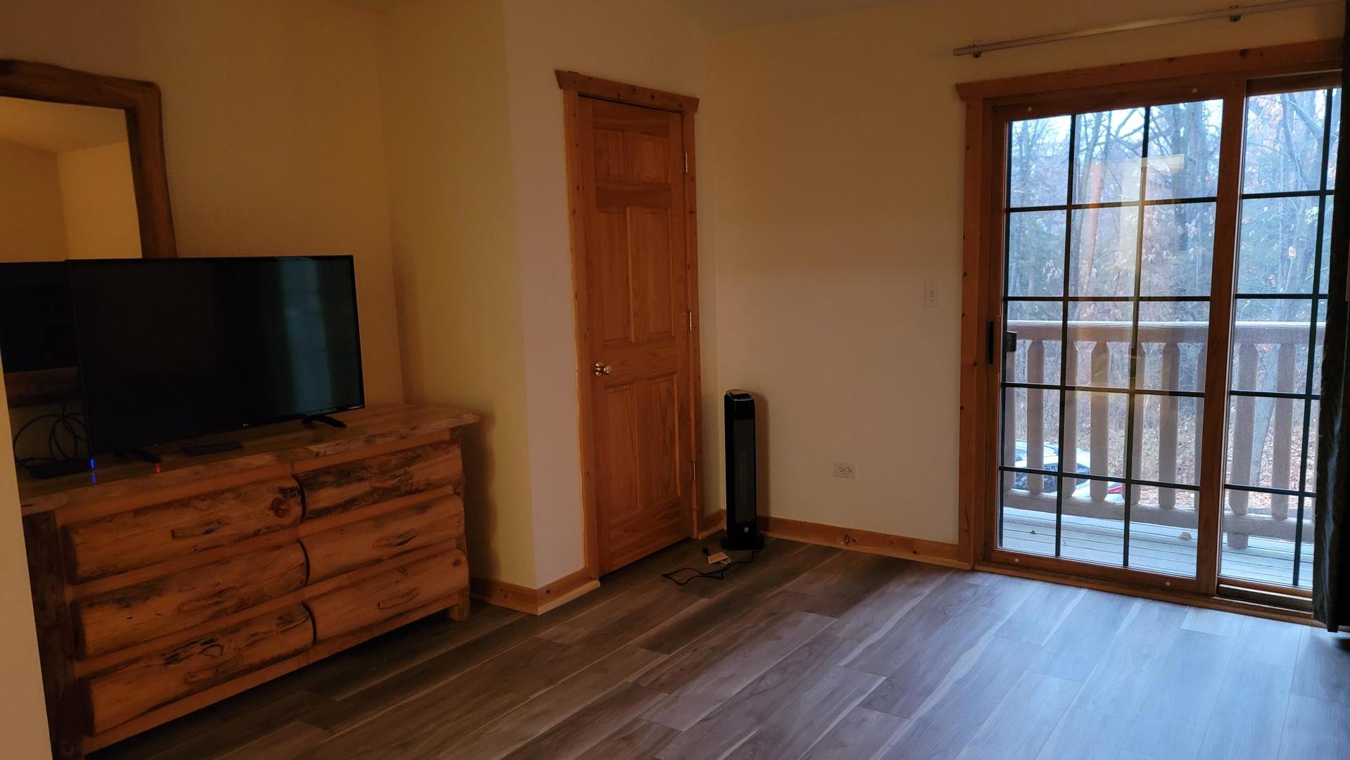 2643 North Il Route 178, Unit Q3 Utica, IL 61373 - Photo 6 of 10 a living room with hardwood floor and flat screen tv