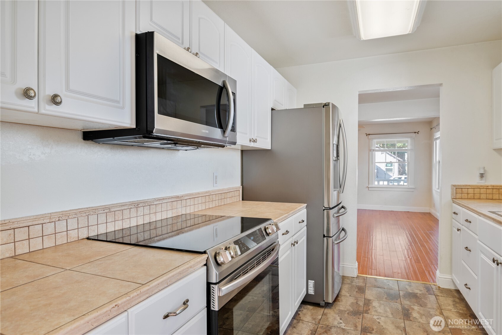 348 22nd Avenue Longview, WA 98632 - Photo 13 of 31 a kitchen with stainless steel appliances white cabinets and a stove top oven
