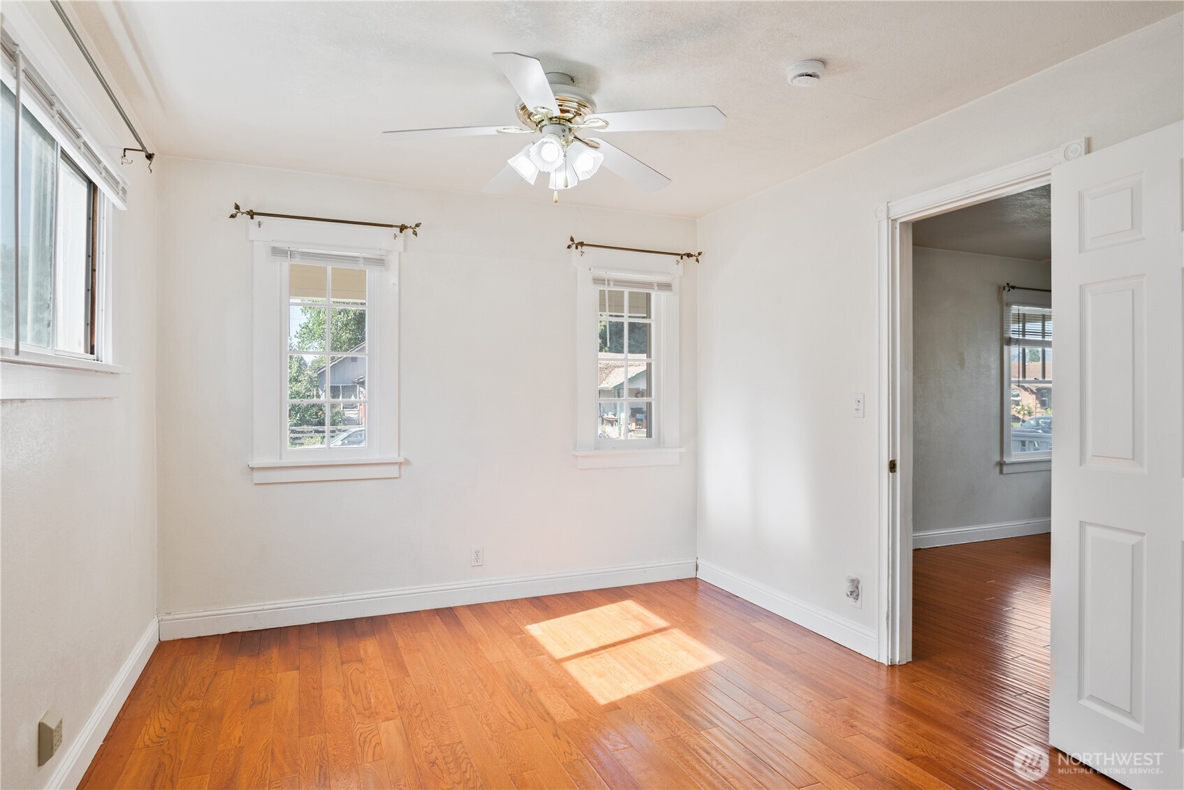 348 22nd Avenue Longview, WA 98632 - Photo 17 of 31 an empty room with wooden floor chandelier fan and windows