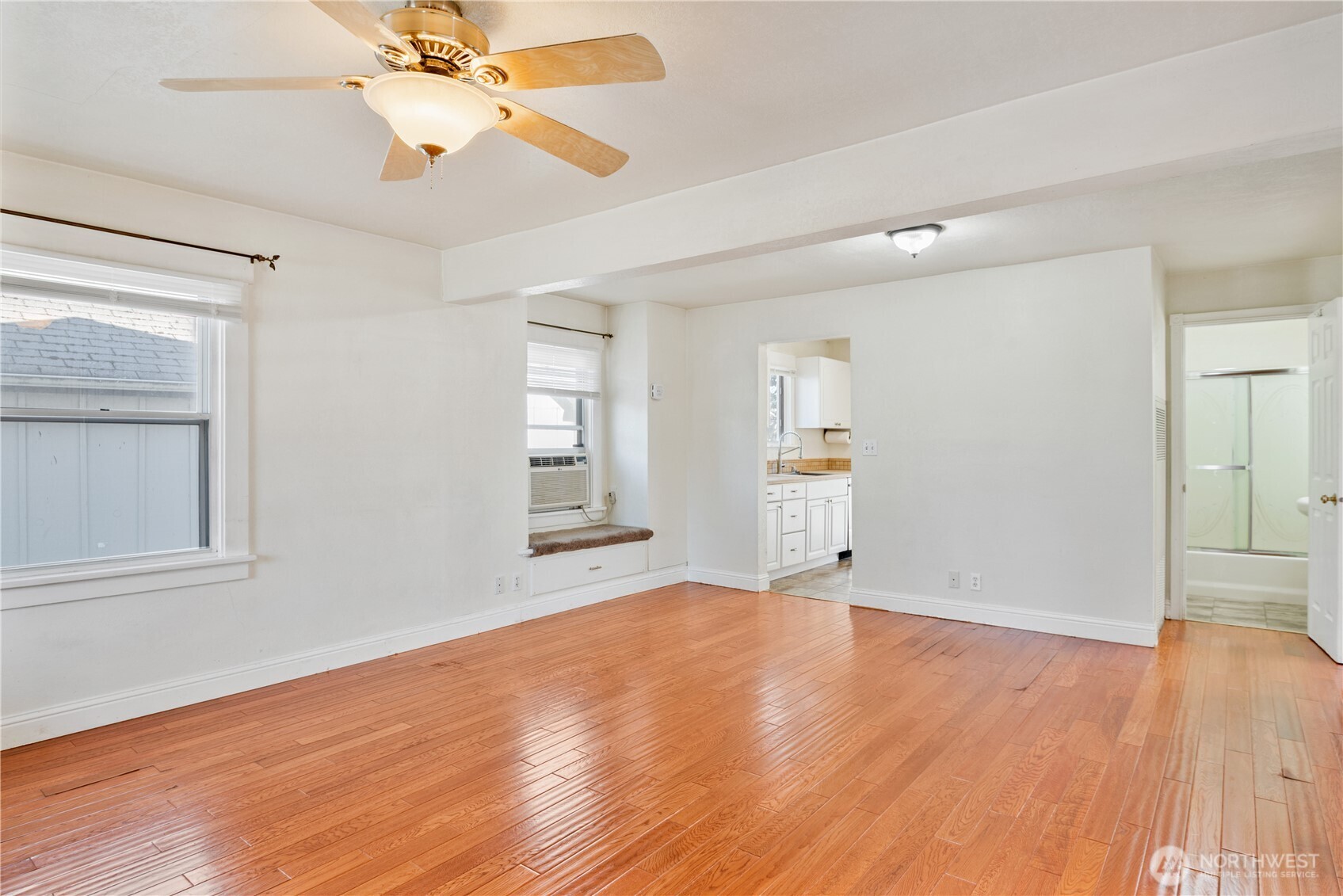 348 22nd Avenue Longview, WA 98632 - Photo 9 of 31 an empty room with wooden floor chandelier fan and windows