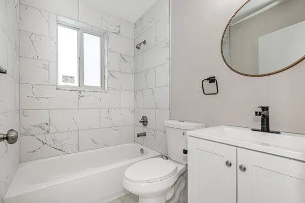 a bathroom with a sink a toilet and a bathtub