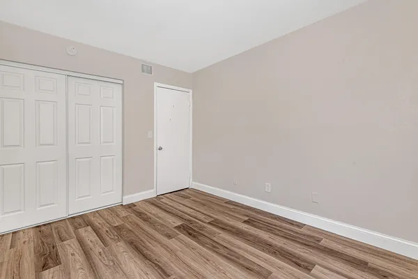 a view of a room with wooden floor