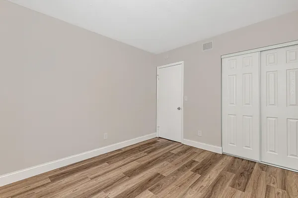 a view of a room with wooden floor