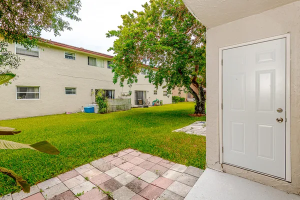 a view of backyard of house with green space