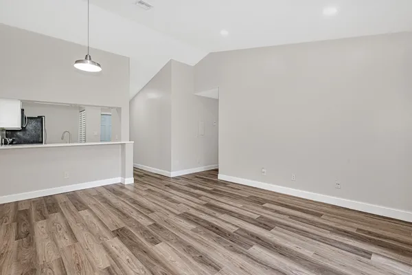 a view of wooden floor and a chandelier in closet
