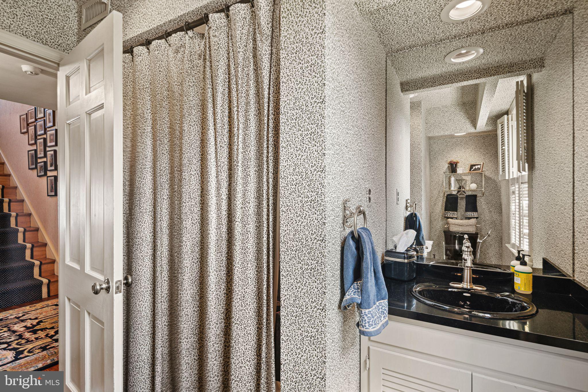 902 Warwick Road Haddonfield, NJ 08033 - Photo 26 of 43 a bathroom with a granite countertop sink and a mirror
