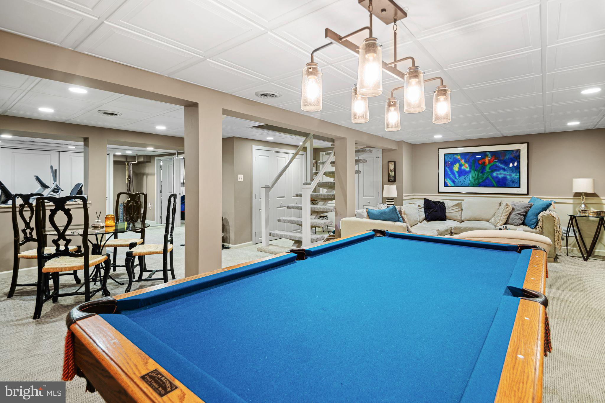 902 Warwick Road Haddonfield, NJ 08033 - Photo 32 of 43 a living room with furniture pool table and a chandelier