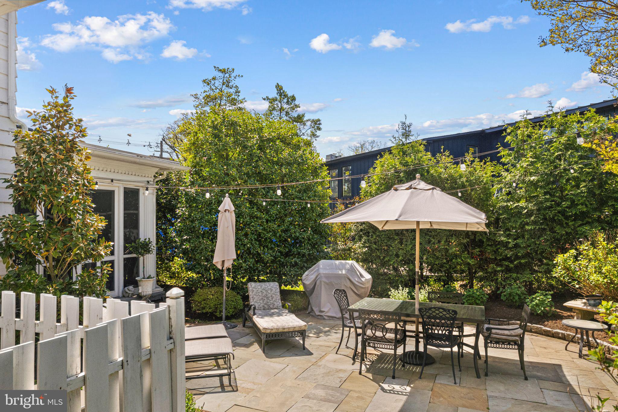 902 Warwick Road Haddonfield, NJ 08033 - Photo 36 of 43 a backyard of a house with table and chairs