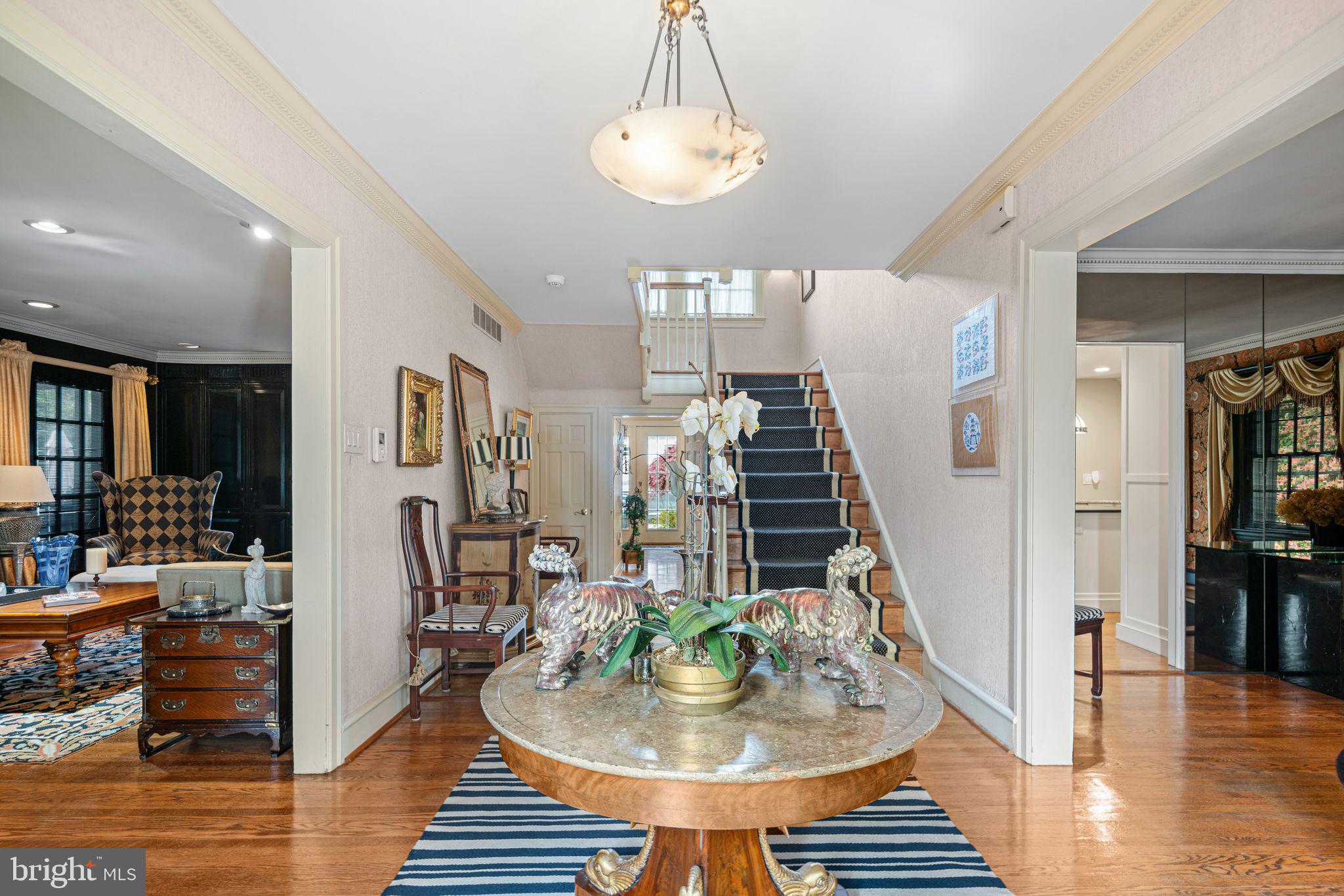 902 Warwick Road Haddonfield, NJ 08033 - Photo 4 of 43 a dining room with wooden floor and a chandelier