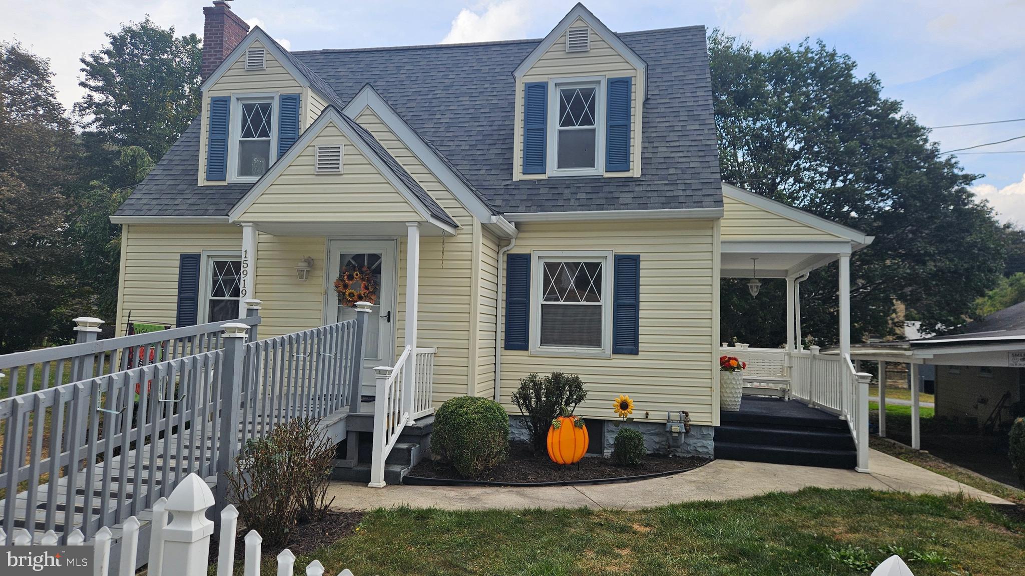 a view of a house with a yard and furniture