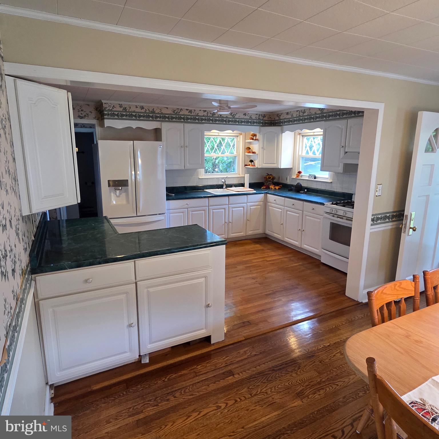 15919 Foundry Row Northwest Mount Savage, MD 21545 - Photo 12 of 41 a kitchen with granite countertop a stove and a wooden floors