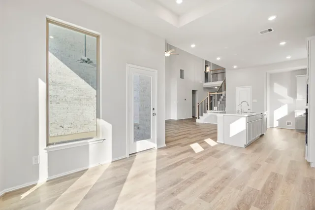 an empty room with a ceiling fan and bathroom