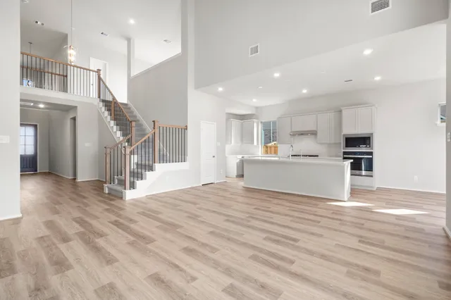 a view of kitchen with kitchen island and stainless steel appliances