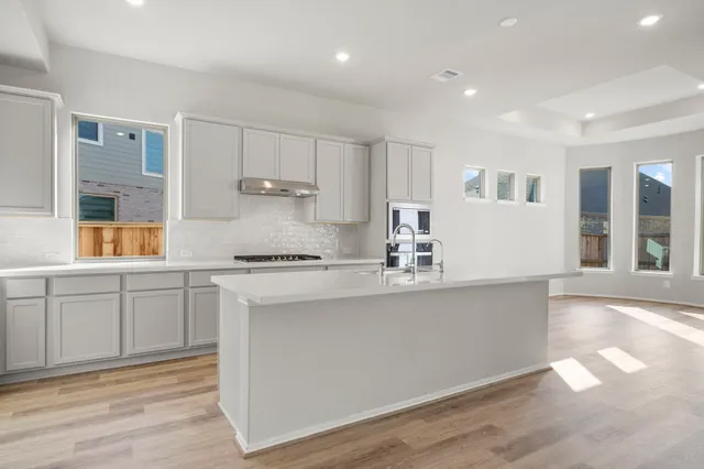 a kitchen with a sink cabinets and window