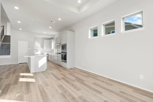 a bathroom with a tub shower and a sink