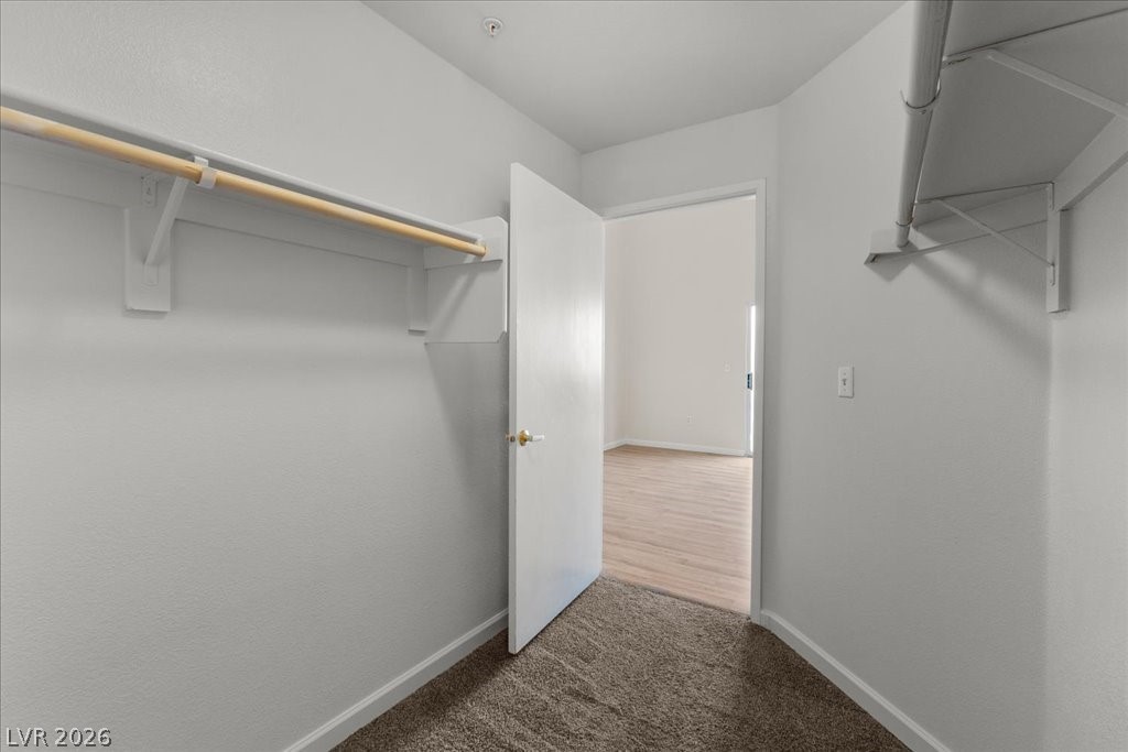 1881 West Alexander Road, Unit 1037 North Las Vegas, NV 89032 - Photo 17 of 31 Functional walk in closet in primary suite features convenient shelving and hanging space for effortless organization.