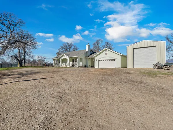 a view of the house with a yard and garage