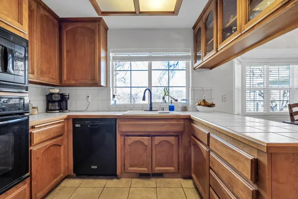 a kitchen with stainless steel appliances granite countertop a stove and a sink