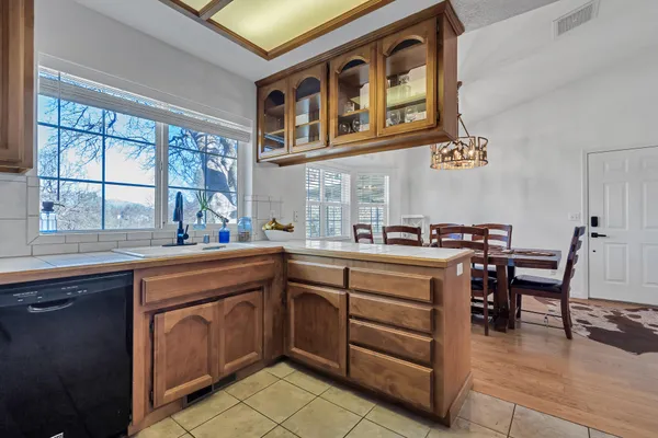 a kitchen with cabinets a sink and appliances