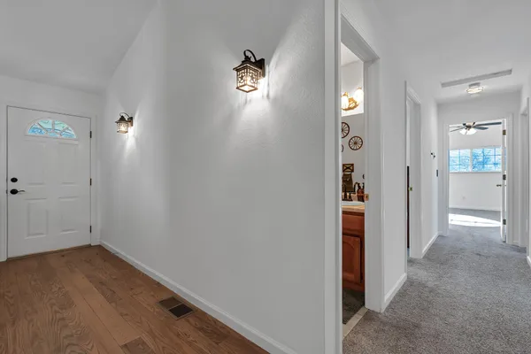 a view of a livingroom with a ceiling fan and window