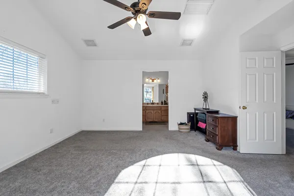 a view of a yard with wooden fence